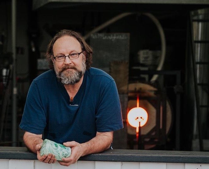 Bob at the Campbell River Studio holding a tumbler