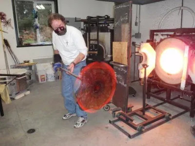 Bob spinning out a glass plate in the old studio on Quadra Island